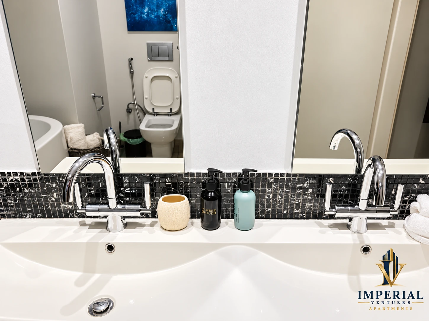Double vanity with mirrors and bathroom amenities